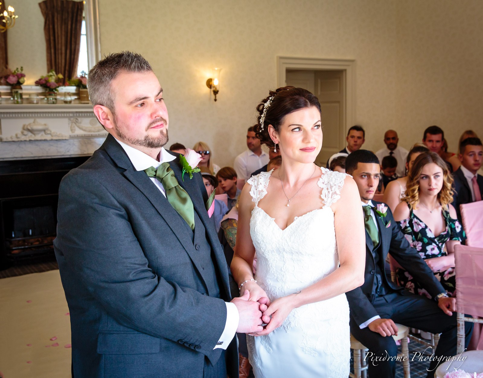 Bride and groom holding hands as they exchange their vows