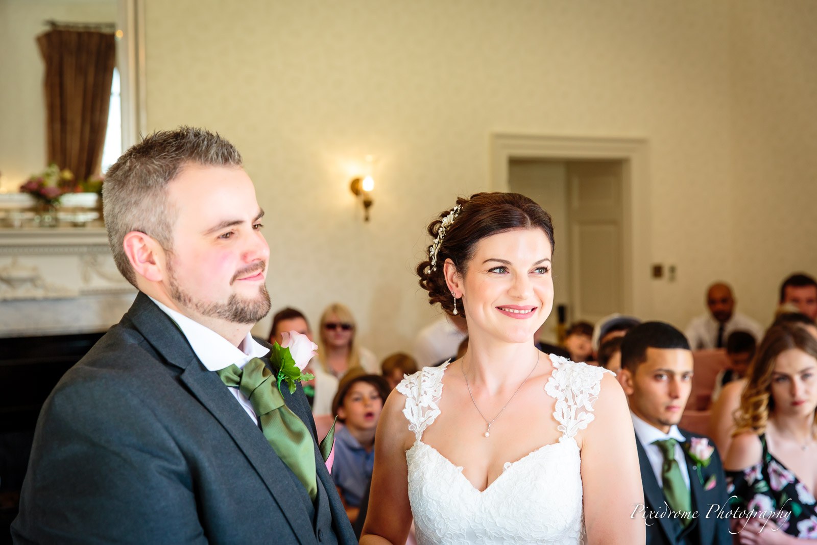 The couple standing side by side during the ceremony