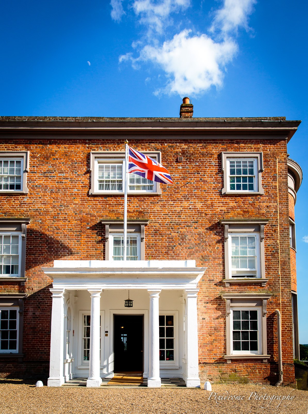 The red-brick Georgian frontage of Highfield Park with a Union flag above the portico