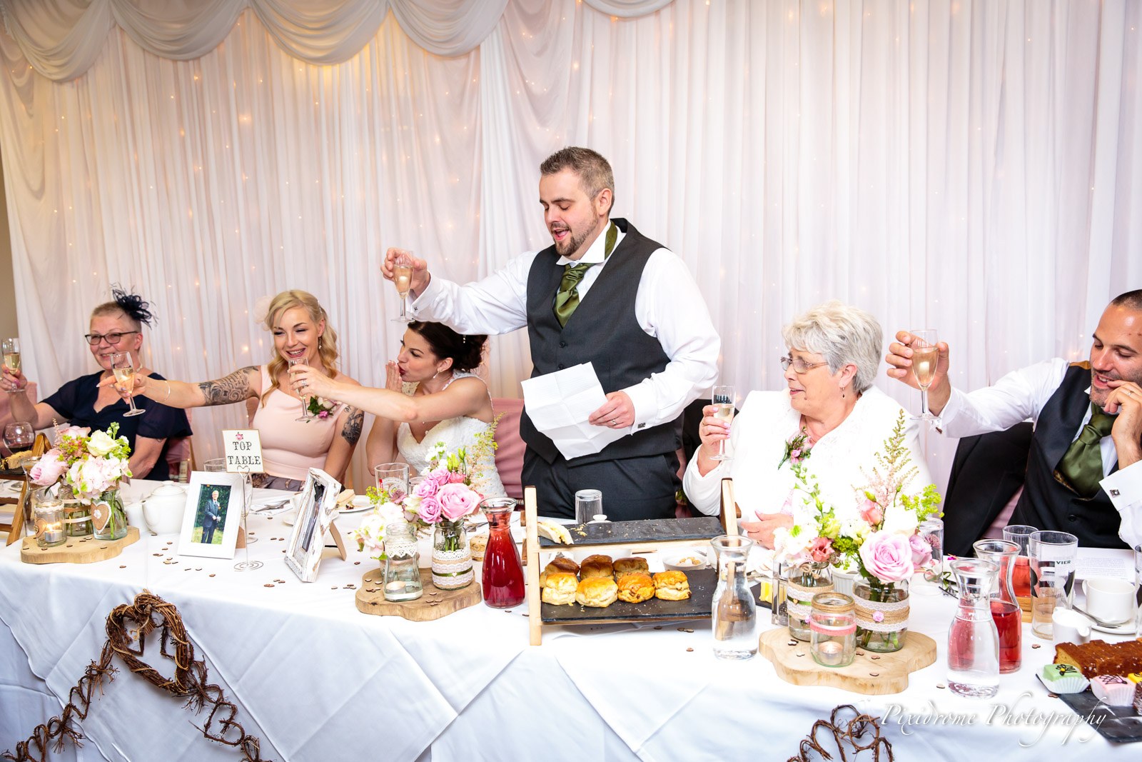 The top table during the speeches, the groom on his feet