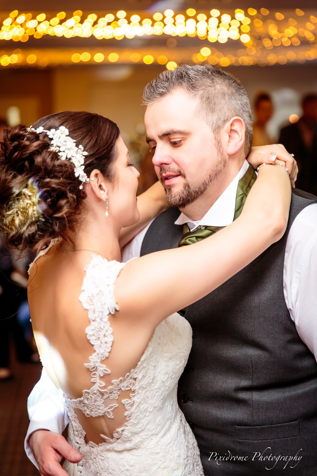 The couple's first dance beneath a canopy of warm fairy lights