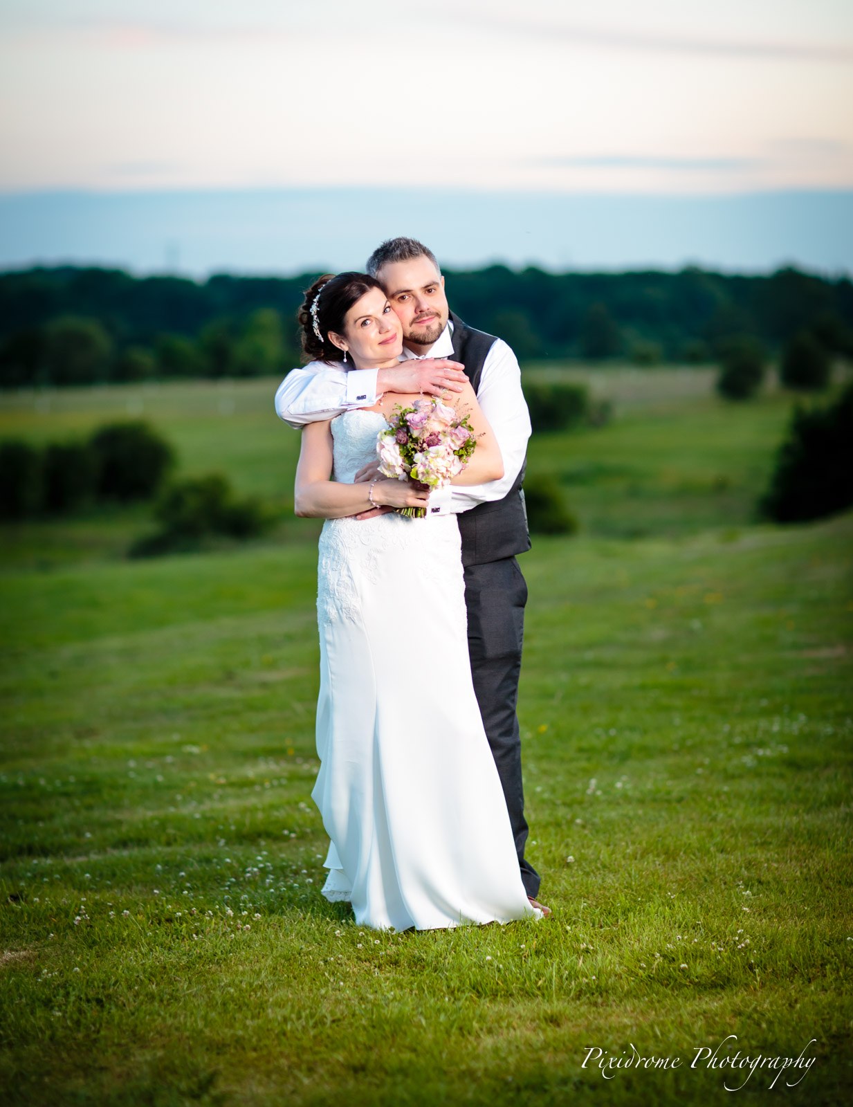 The newlyweds together in the open parkland of Highfield Park
