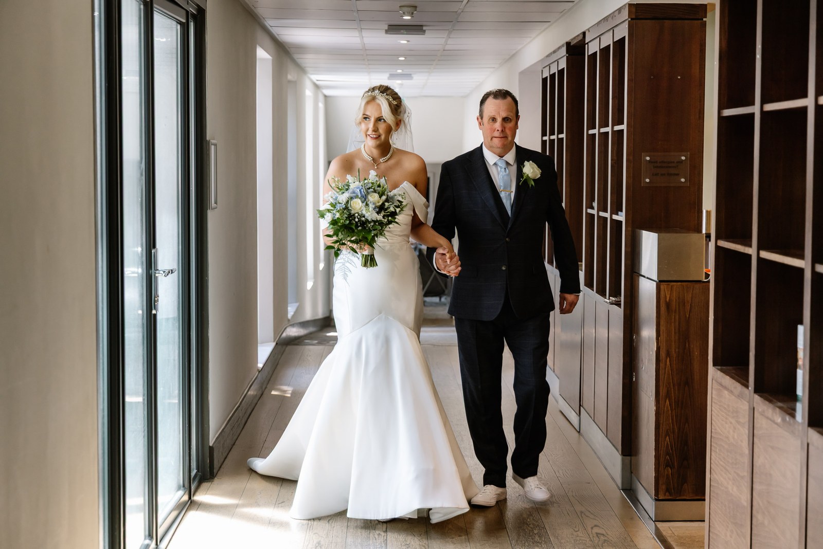 The bride and her father walking the corridor towards the ceremony