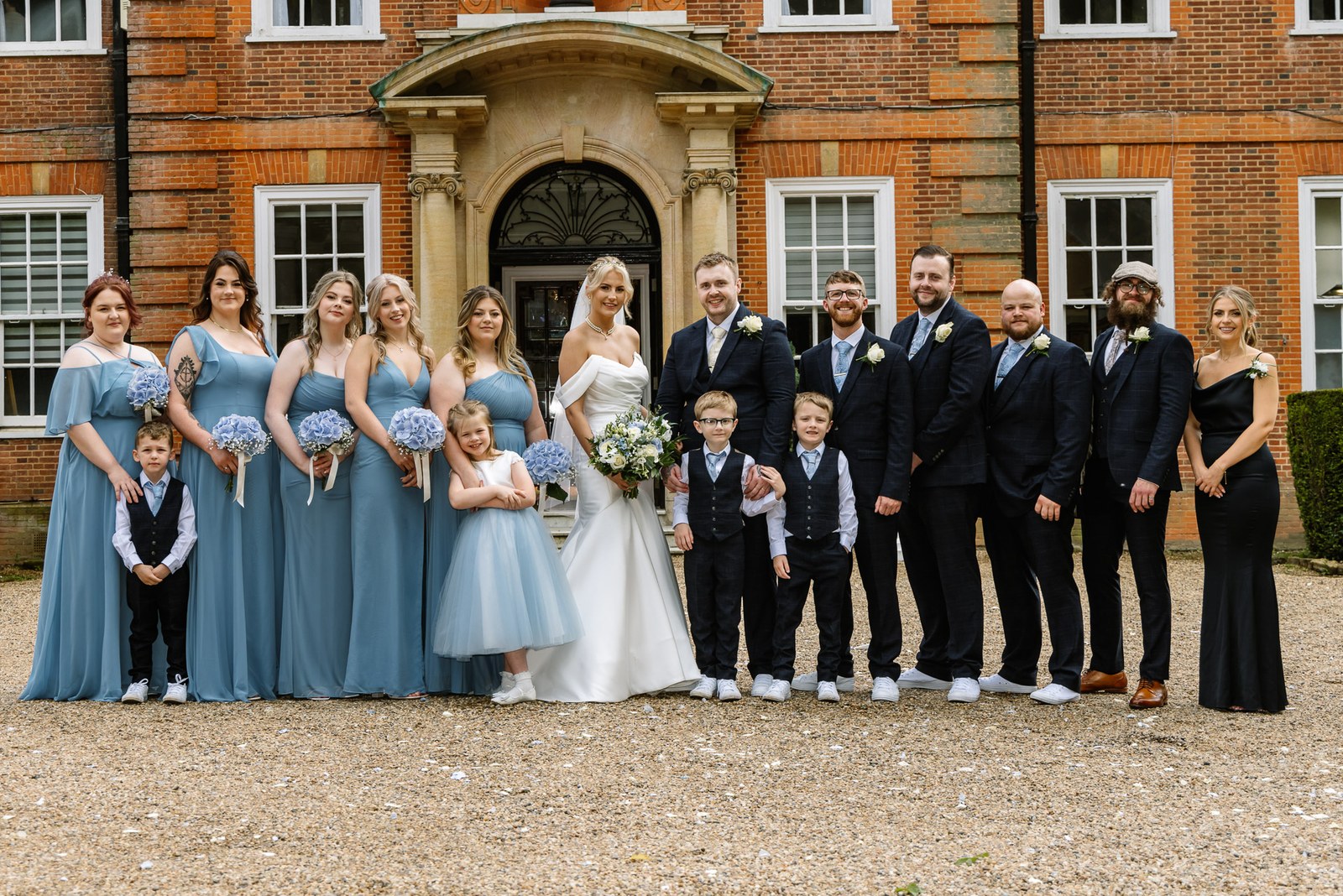The full wedding party posed at the entrance of Hunton Park Hotel