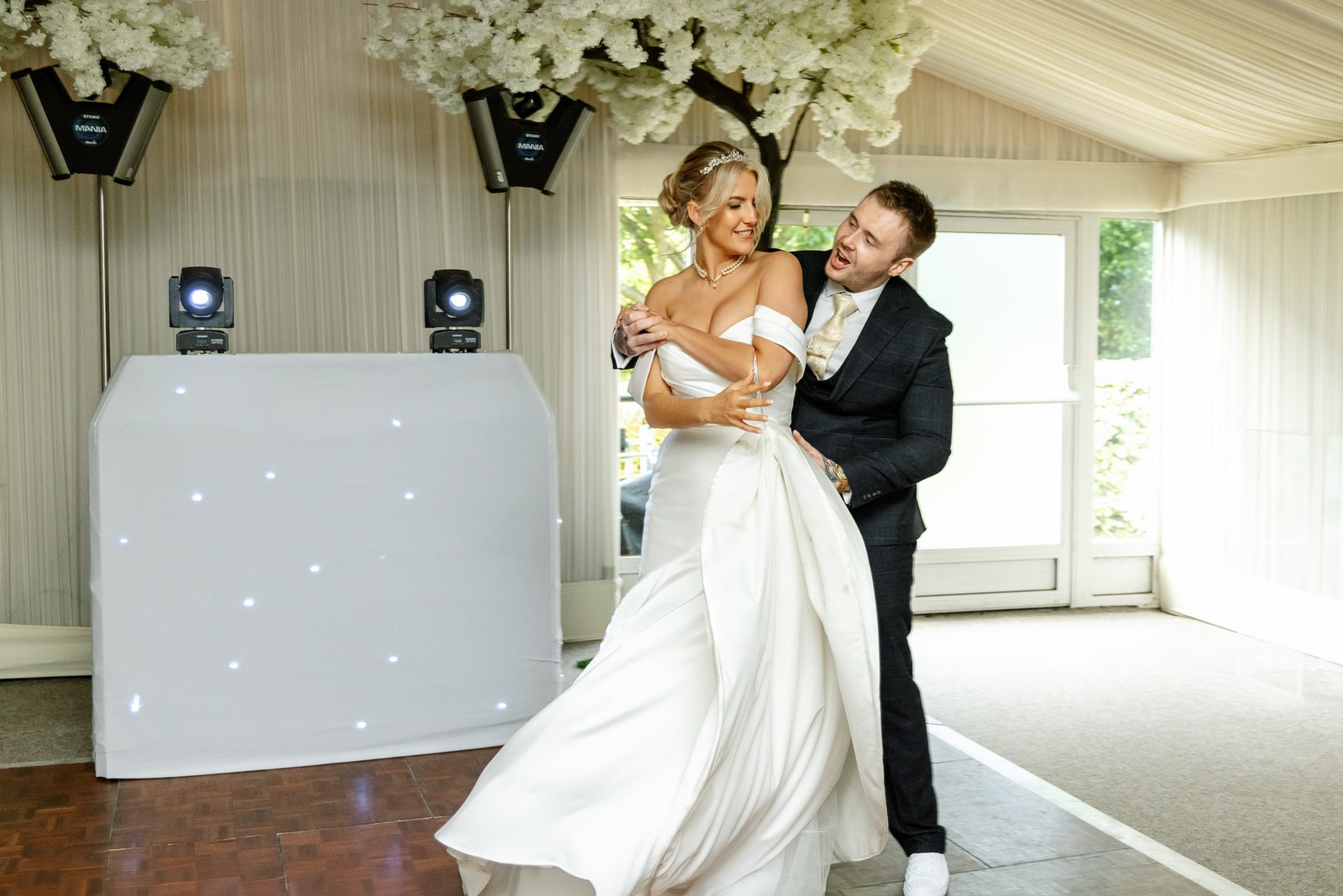 The couple dancing beneath the blossom trees in the orangery at Hunton Park Hotel