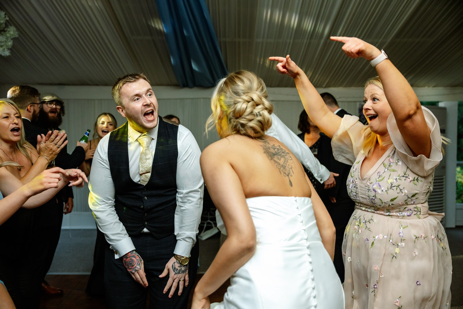 Guests packed around the bride on the dance floor during the party