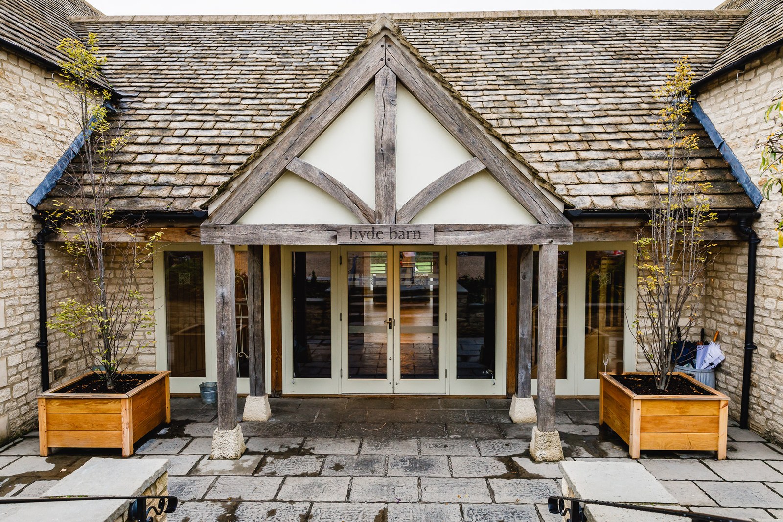 The oak-framed Cotswold stone entrance to Hyde House on the morning of the wedding