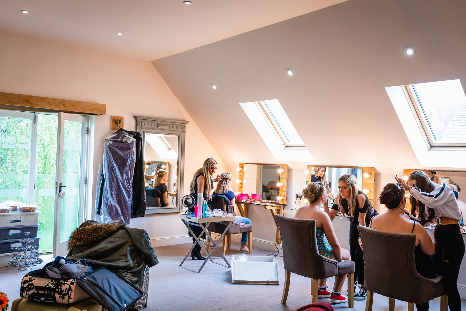 The bridal suite under sloping skylights as the bridesmaids get ready