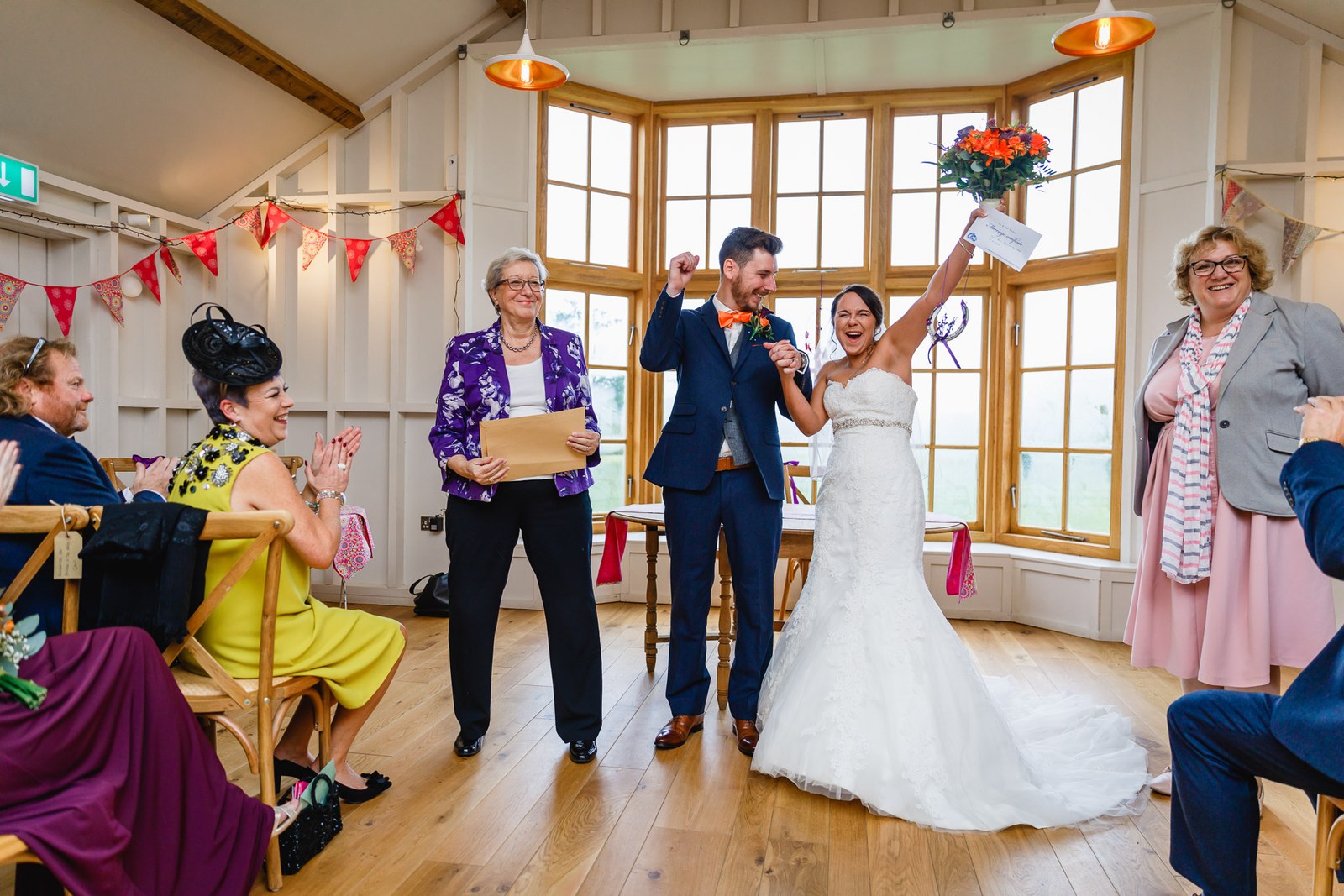 The couple cheering just after being declared married in the barn at Hyde House