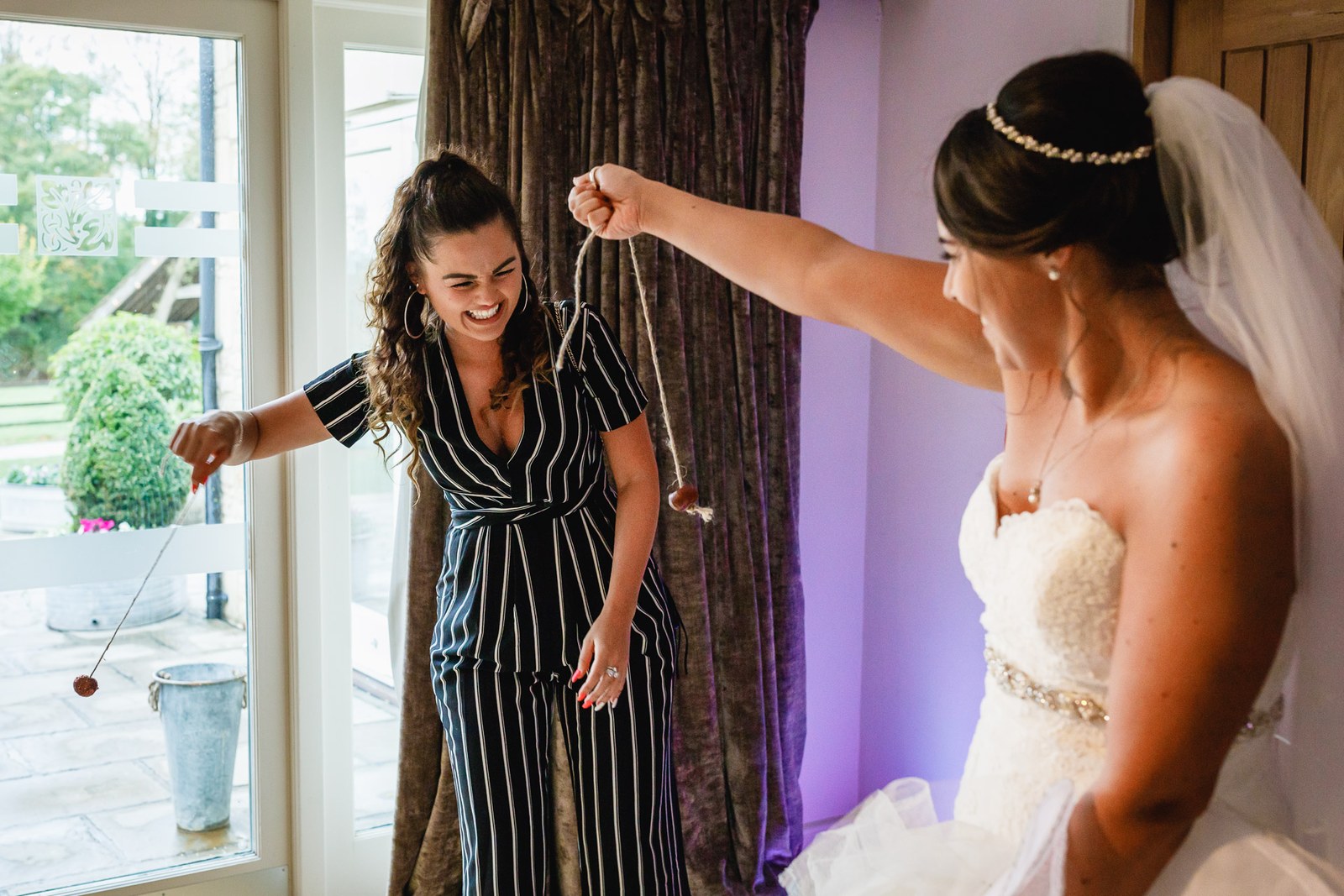 A pendant swung on a thread over the bride's hand in a playful prediction game