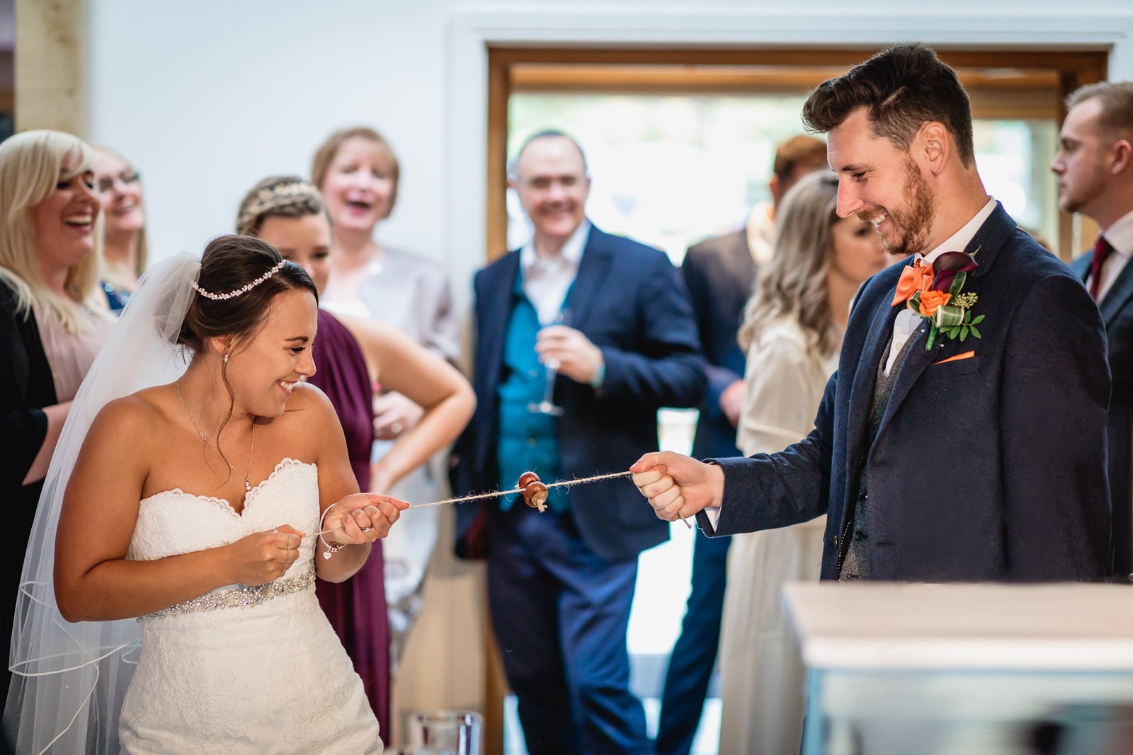 Bride and groom playing the ring-and-string guessing game together