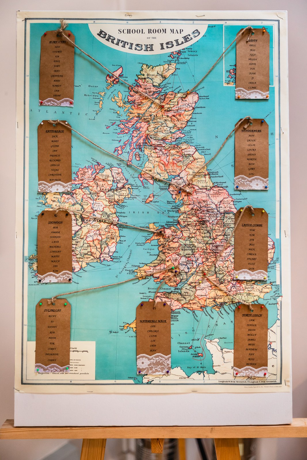 A vintage British Isles map used as the table plan with luggage-tag names