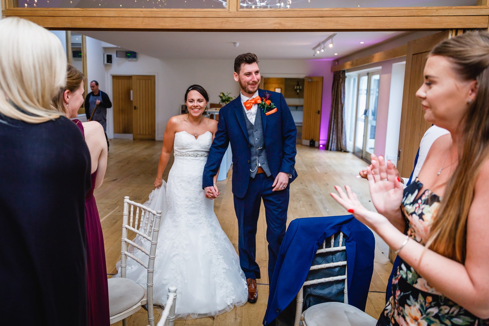 Guests applauding as the newlyweds enter the reception