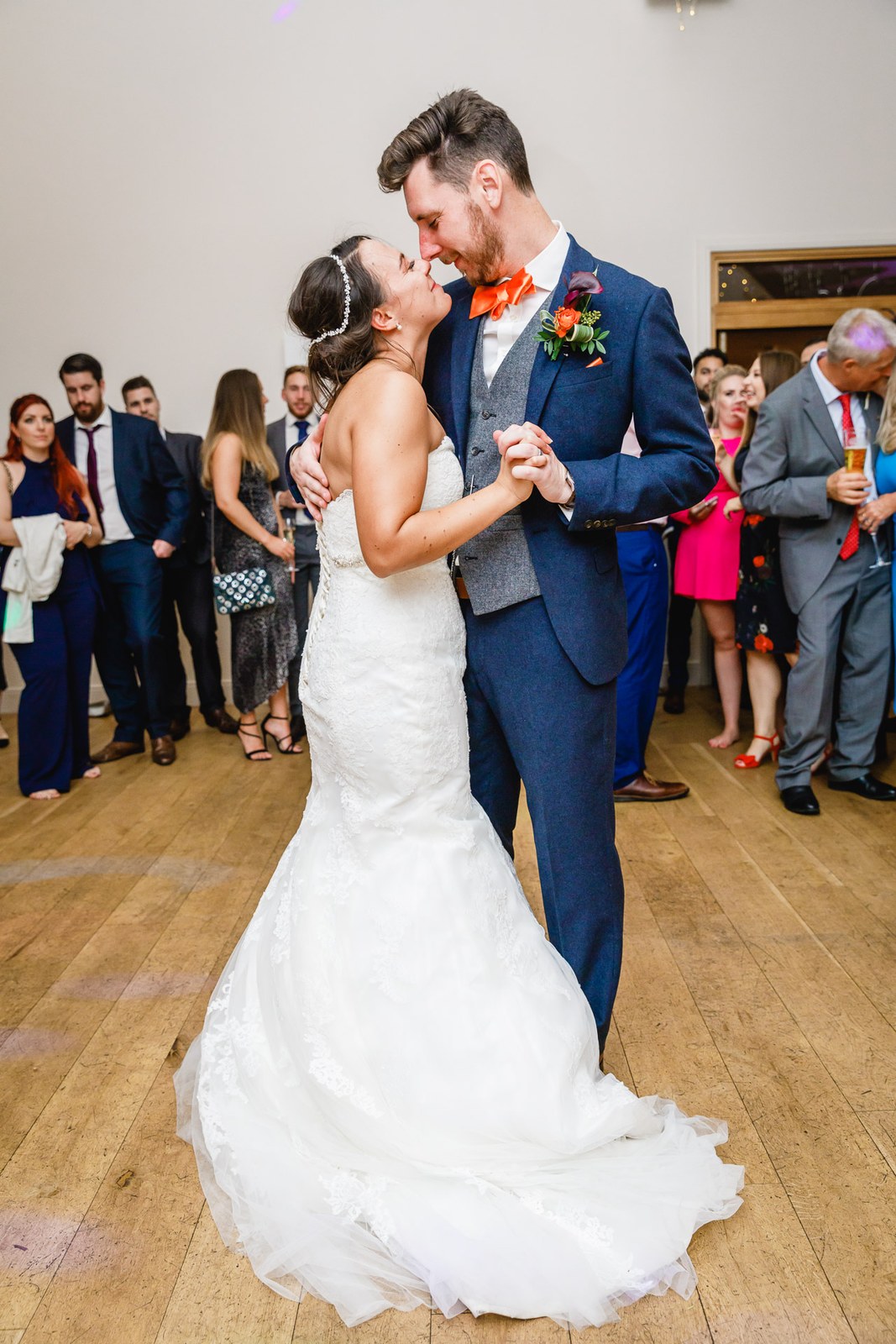 The newlyweds' first dance ringed by their guests in the barn