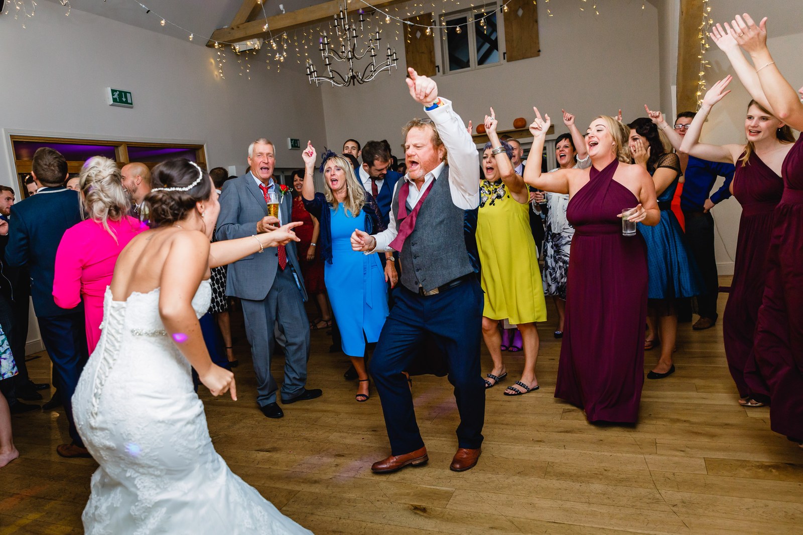 Guests dancing with arms aloft on a lively dance floor