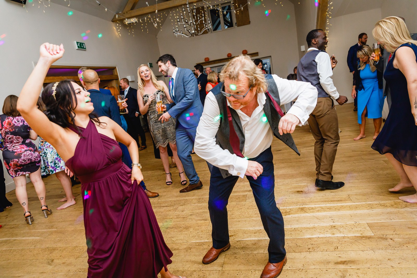 Guests dancing energetically under the party lights