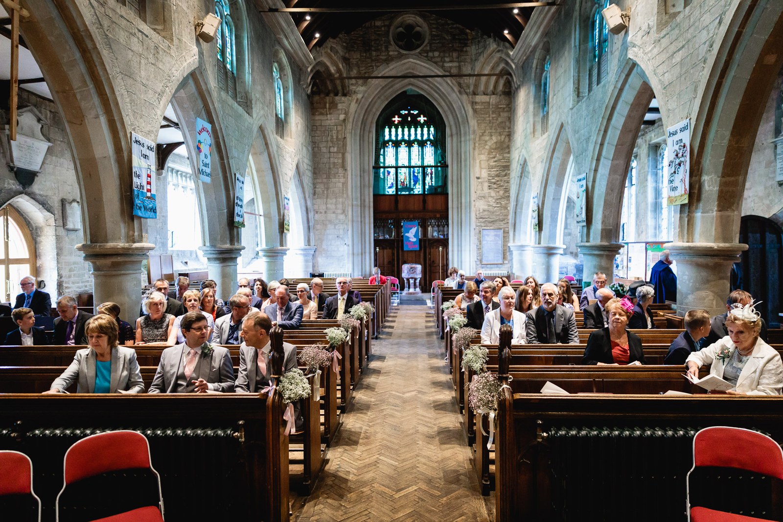 Guests seated in the pews of the stone church before the ceremony