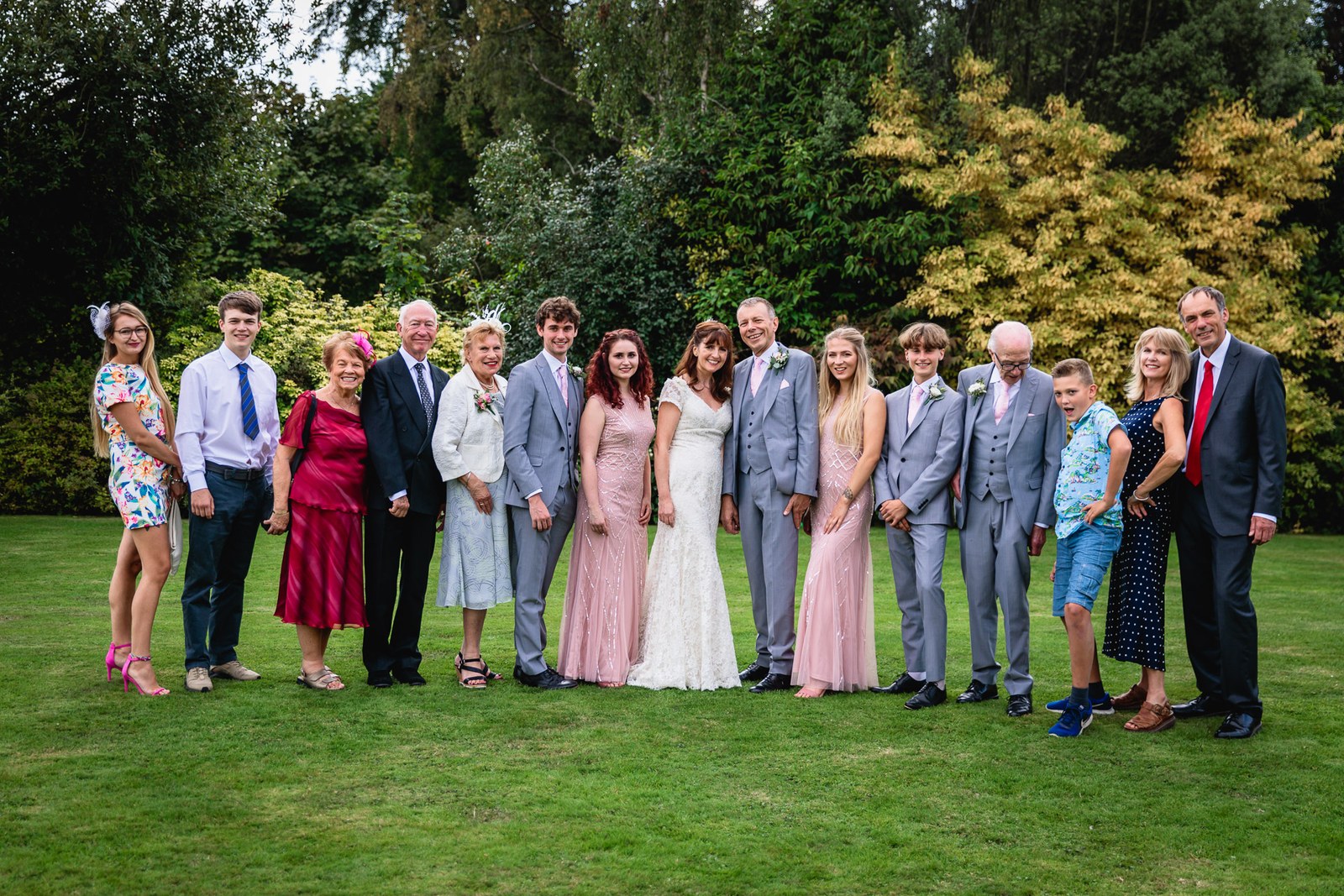 Large family group portrait on the lawn in the hotel grounds
