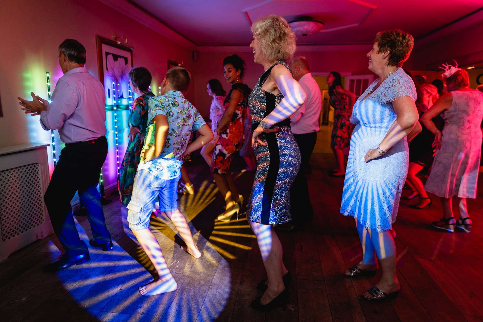 Guests dancing on the floor amid spinning LED light effects