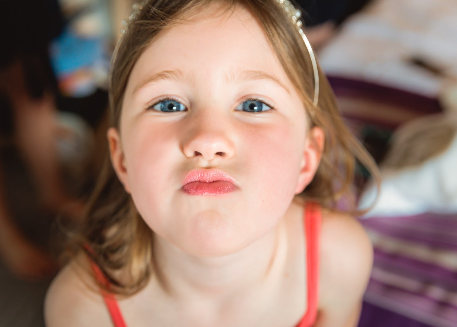 Close-up of a young flower girl pulling a funny face