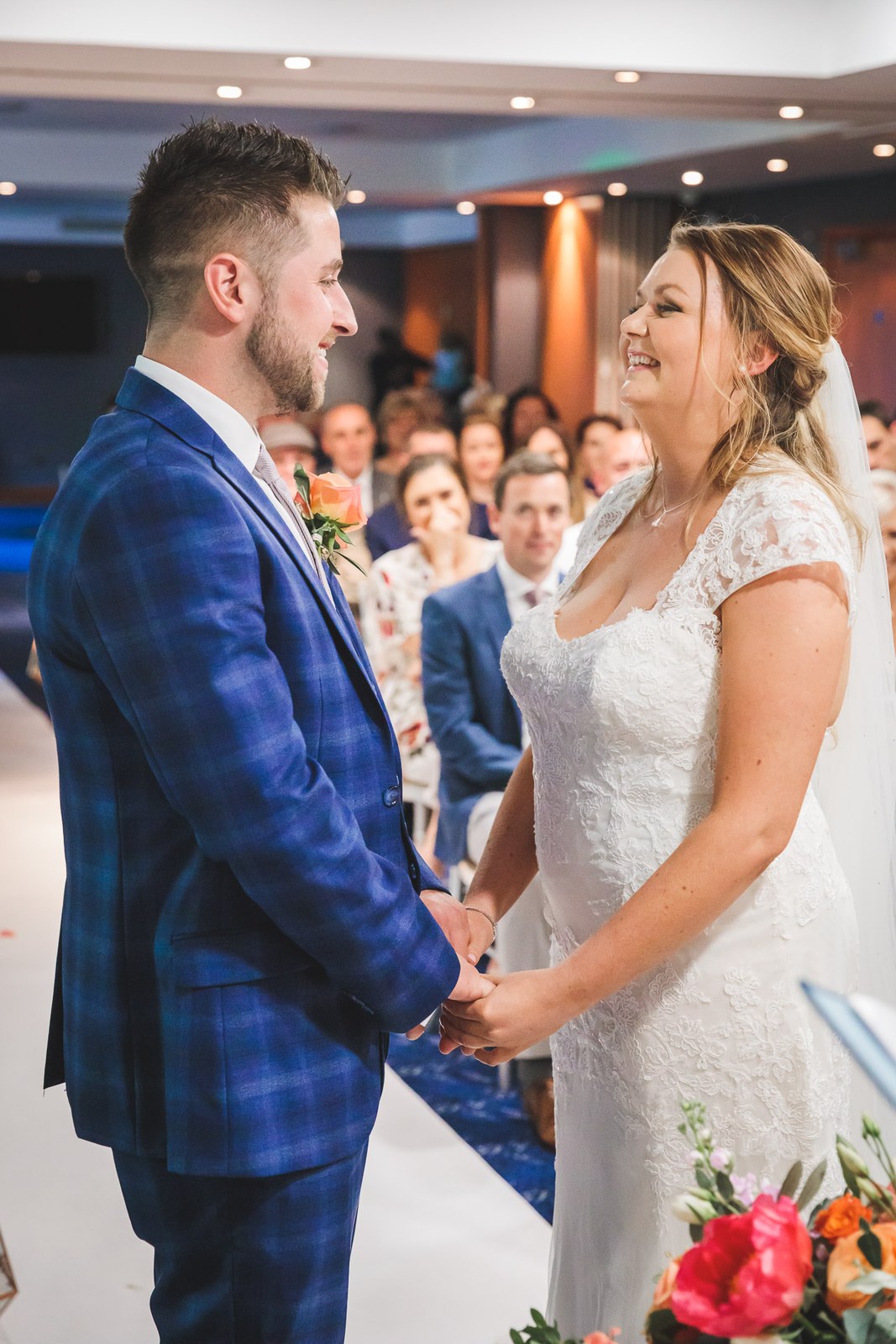 Bride and groom holding hands and facing each other during the ceremony