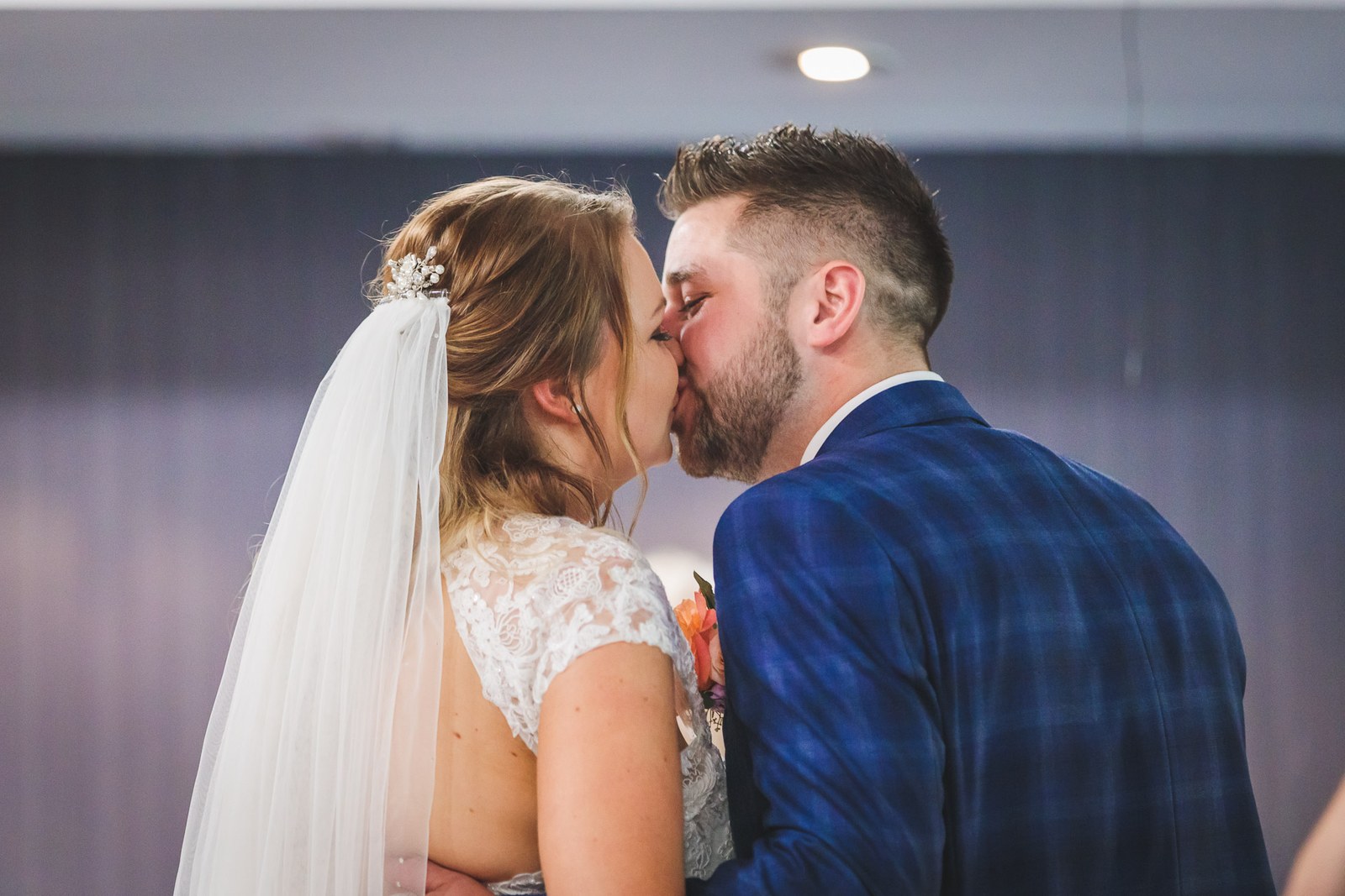 Bride and groom sharing their first kiss