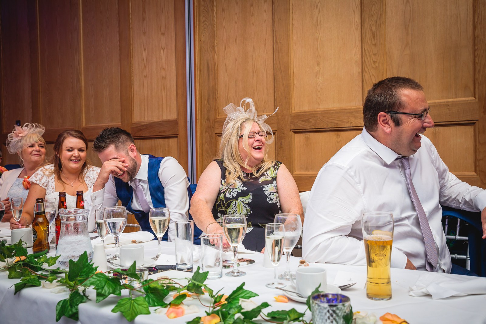 Seated guests sharing a laugh during the wedding speeches