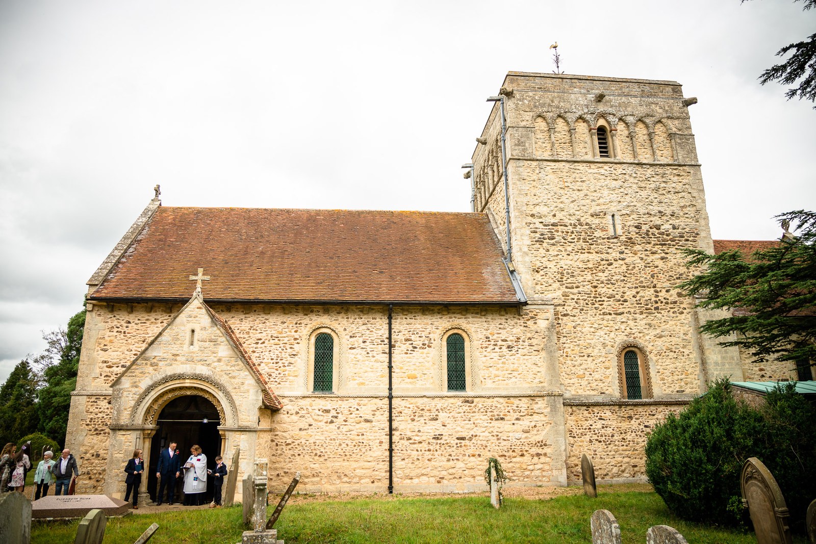 Exterior of the stone parish church with its square Norman tower
