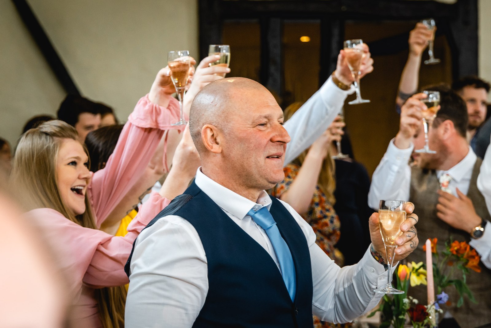 Guests raising their glasses in a toast during the reception