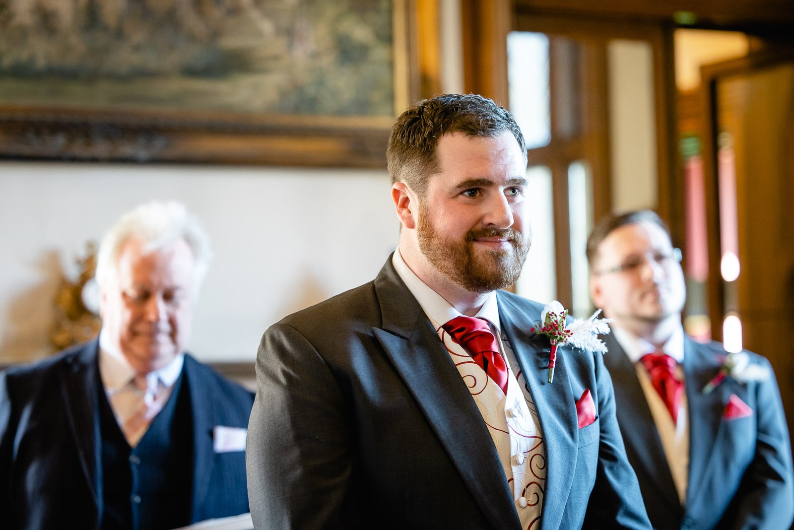The groom and best man waiting at the front of the ceremony room