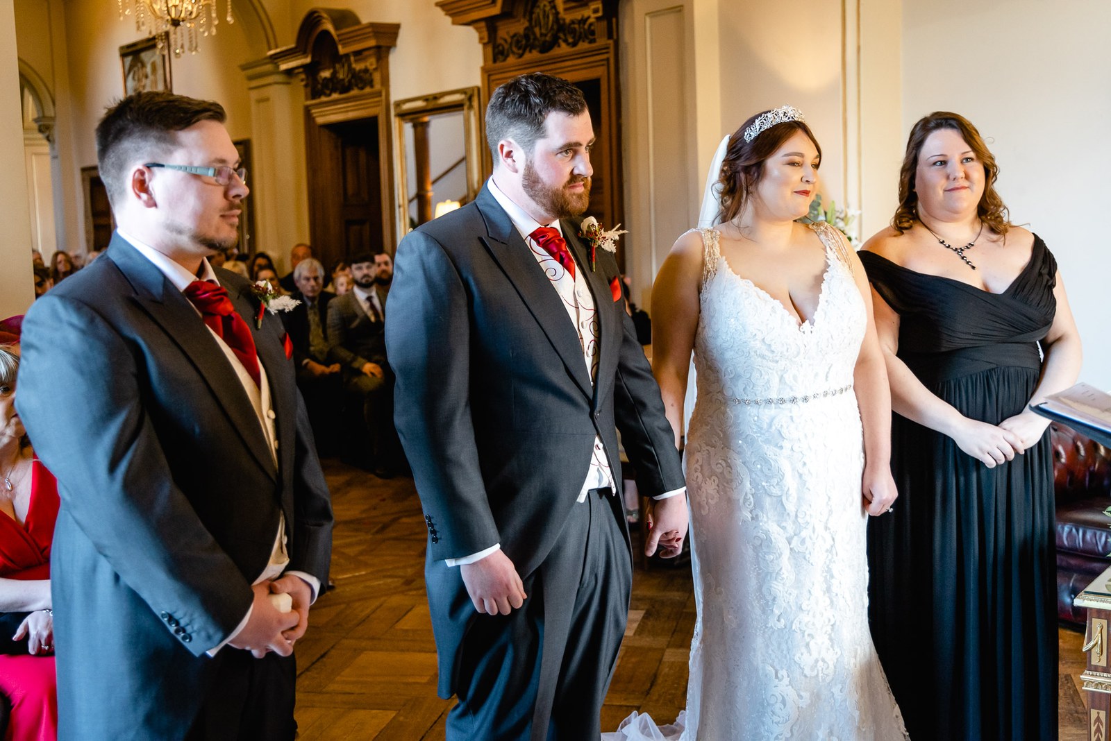 The groom, a groomsman, the bride and a bridesmaid standing together during the ceremony