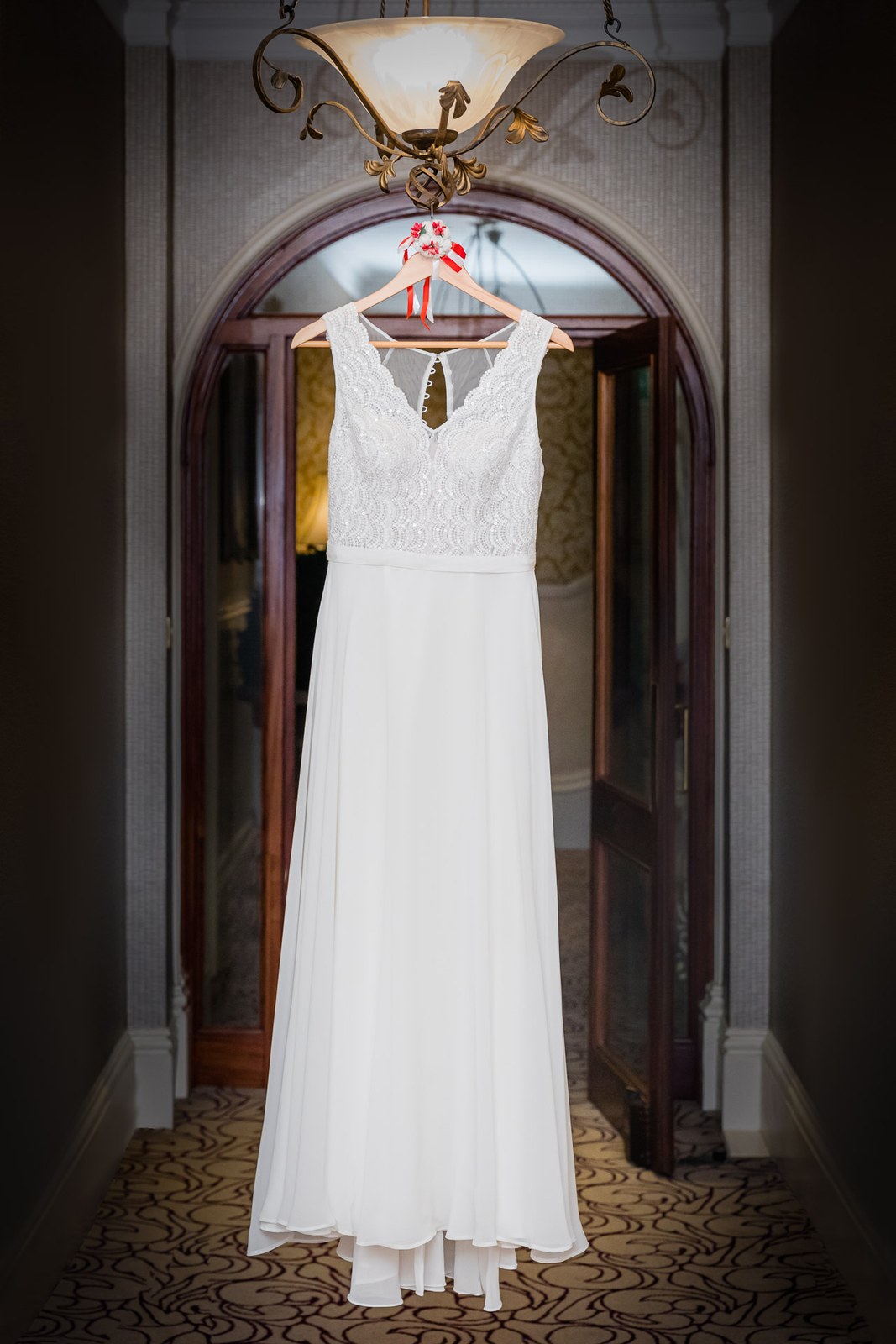 The bride's gown hanging in an arched doorway at The Petersham Hotel