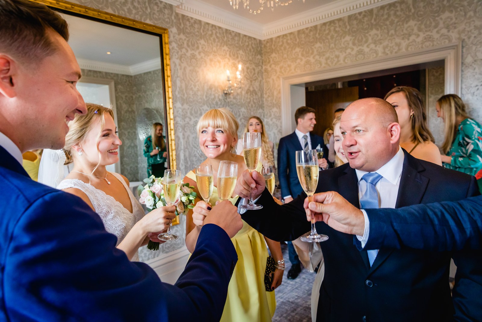The couple toasting champagne with guests at the reception
