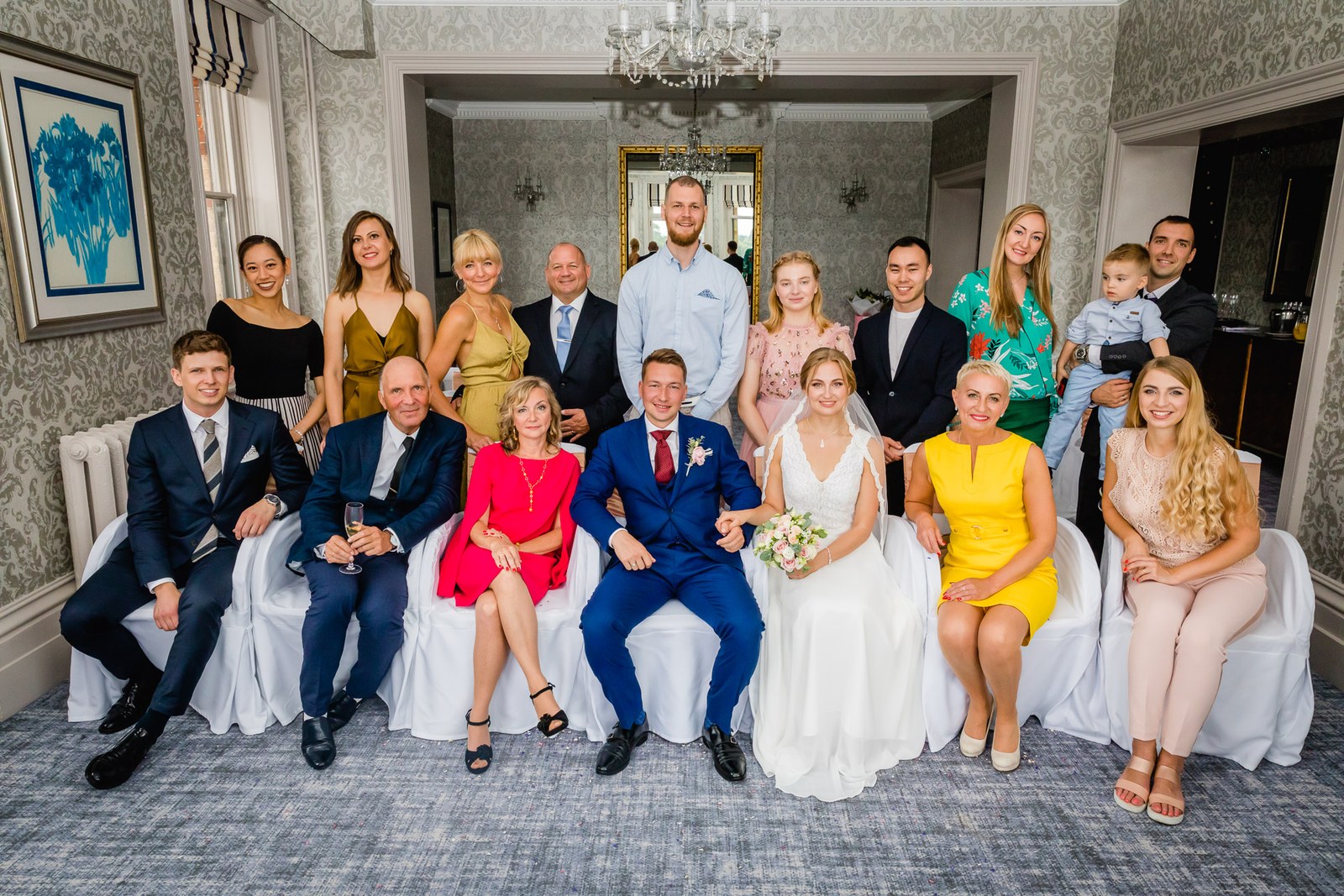Formal group portrait of the wedding party in a reception room at The Petersham Hotel