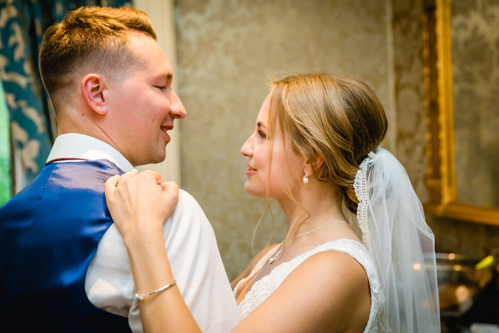 The couple sharing their first dance in a warmly lit room
