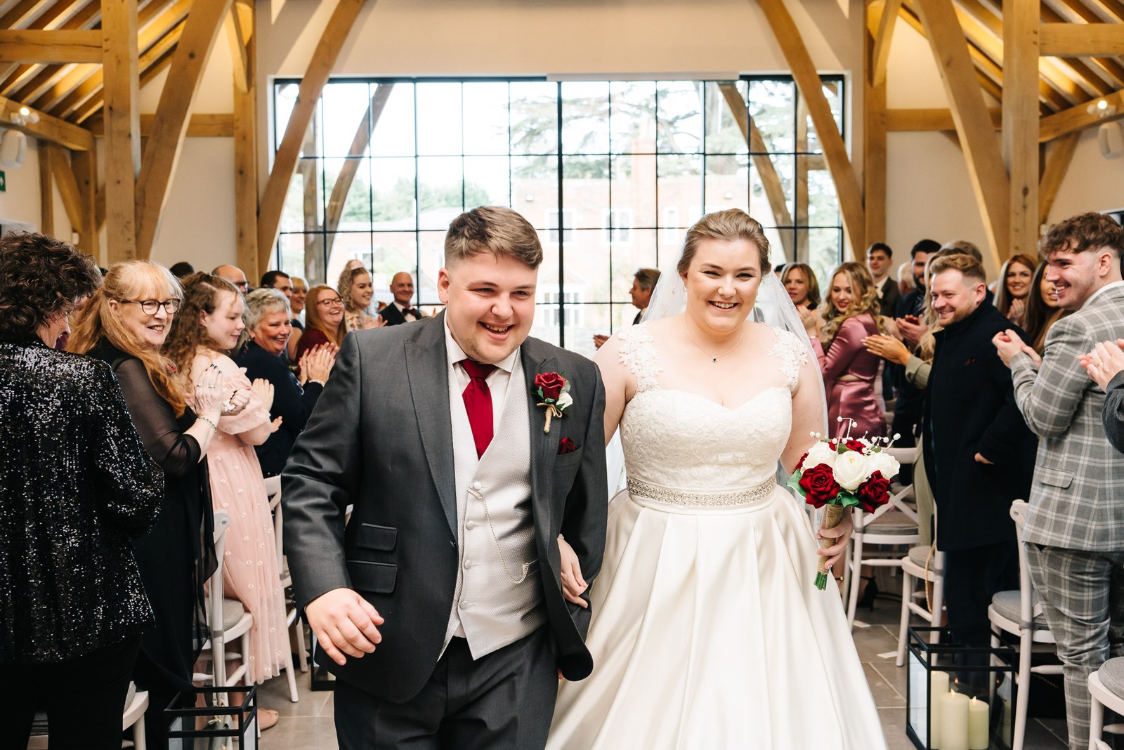 The newlyweds walking back up the aisle through applauding guests