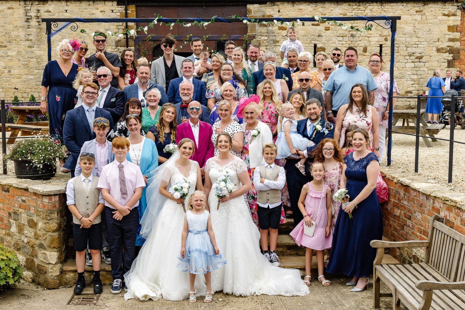 All the guests gathered before the honey-stone frontage of Slapton Manor