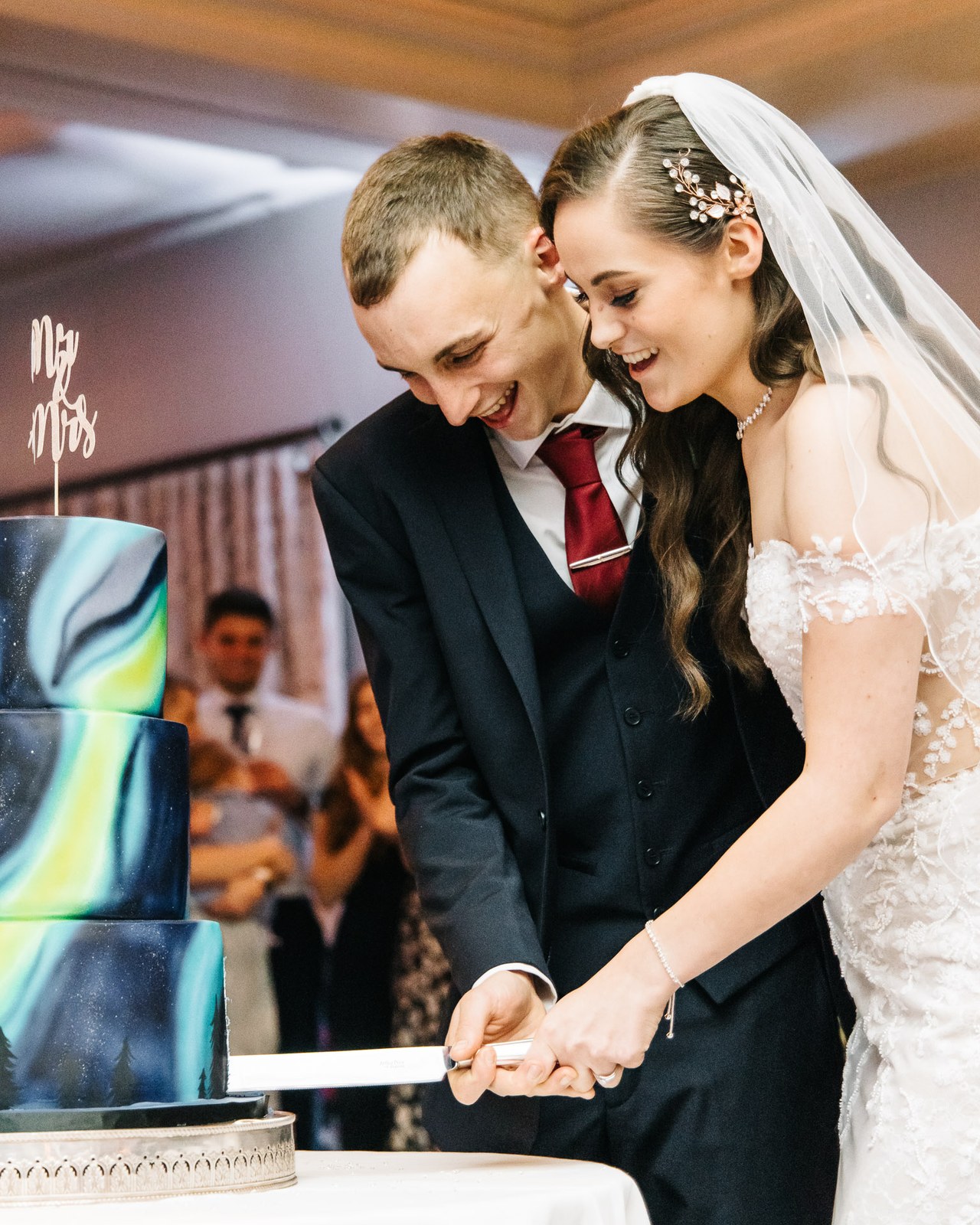 The couple cut their marbled galaxy-tiered wedding cake together