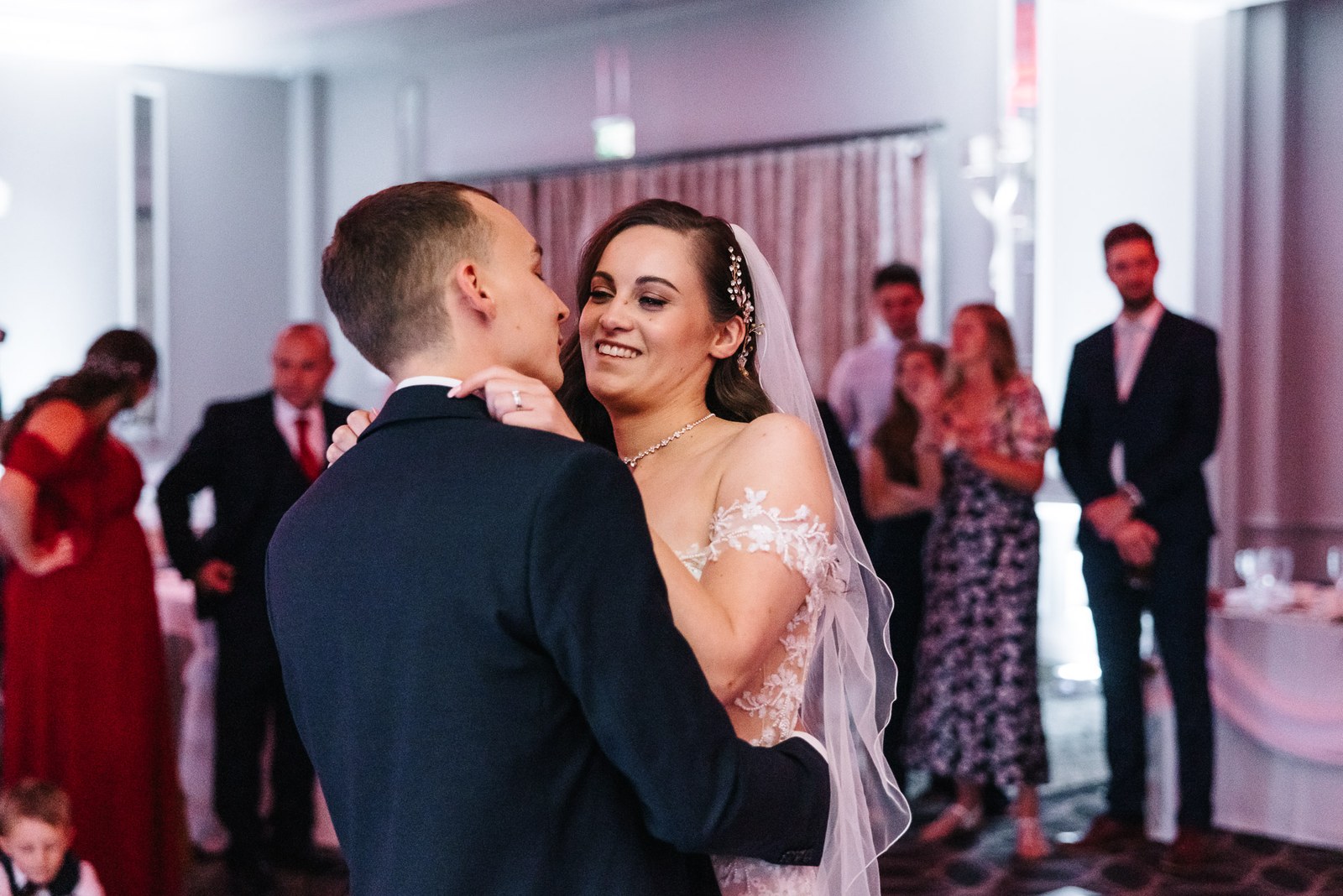 The couple share their first dance surrounded by watching guests