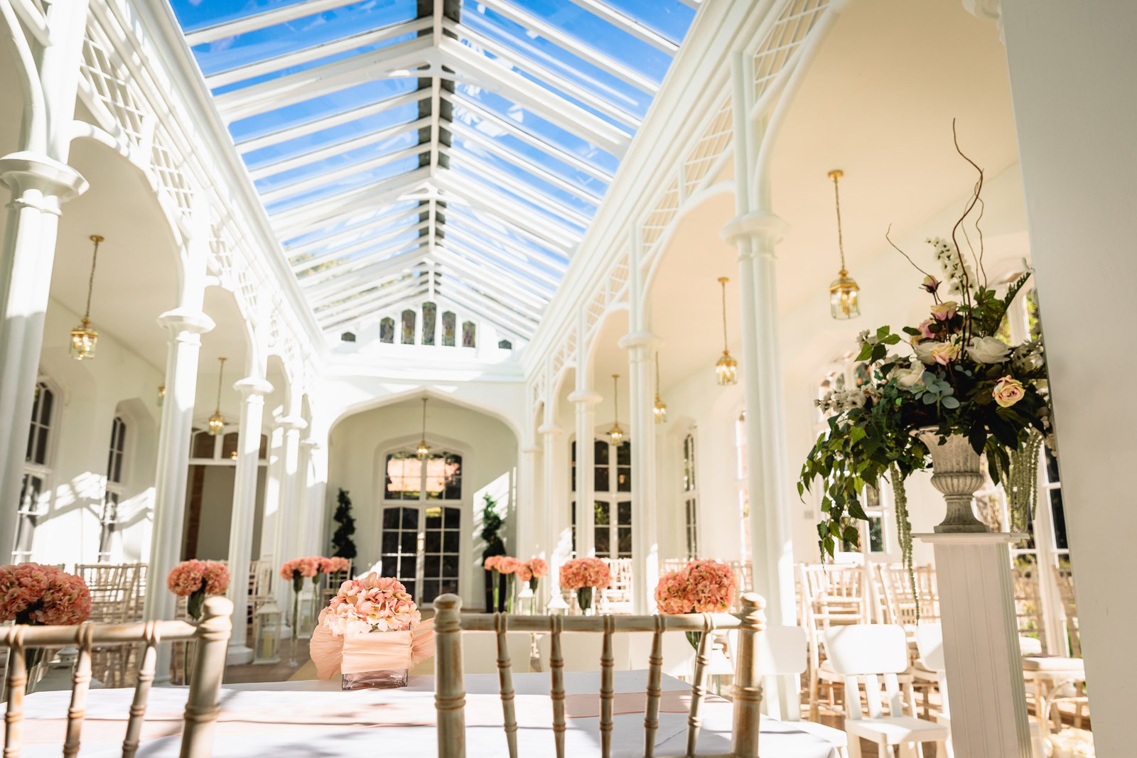 The glass-roofed orangery at St Audries Park set with chairs for the ceremony