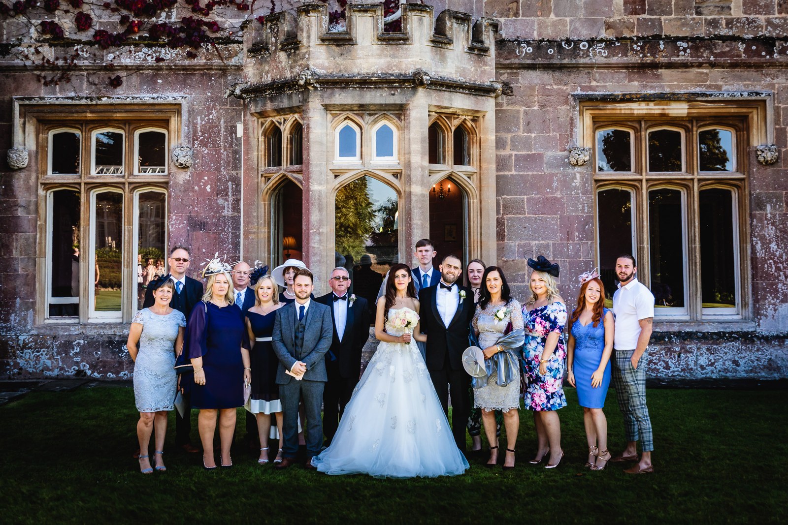 Large group photograph beside the Gothic windows of St Audries Park