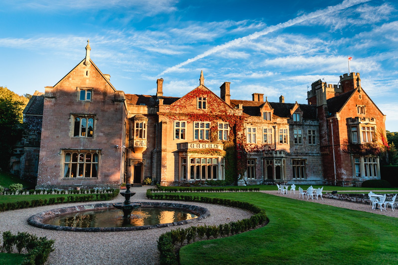 St Audries Park glows at golden hour above its formal fountain garden
