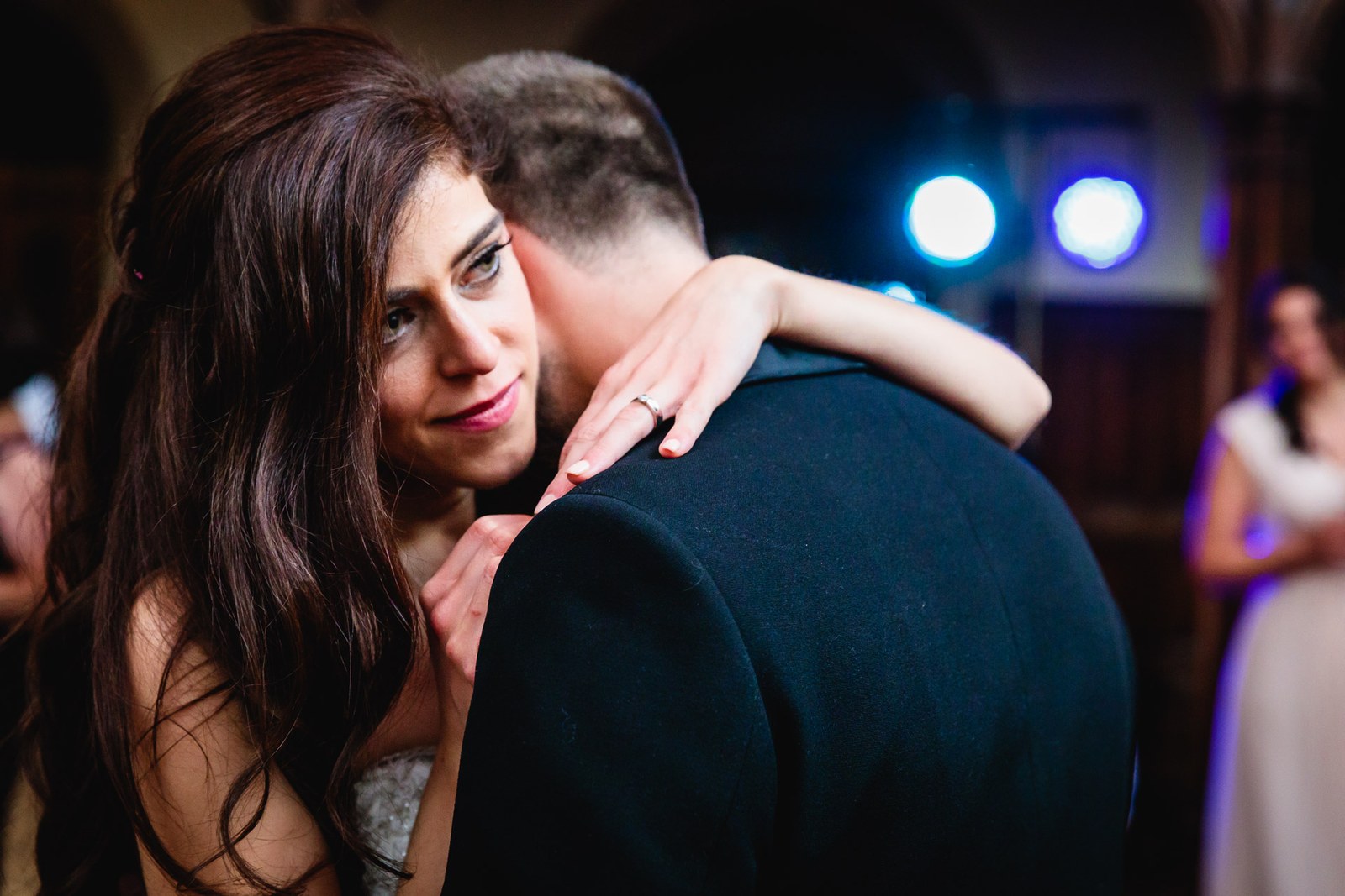 Close-up of the couple's slow dance under blue stage light