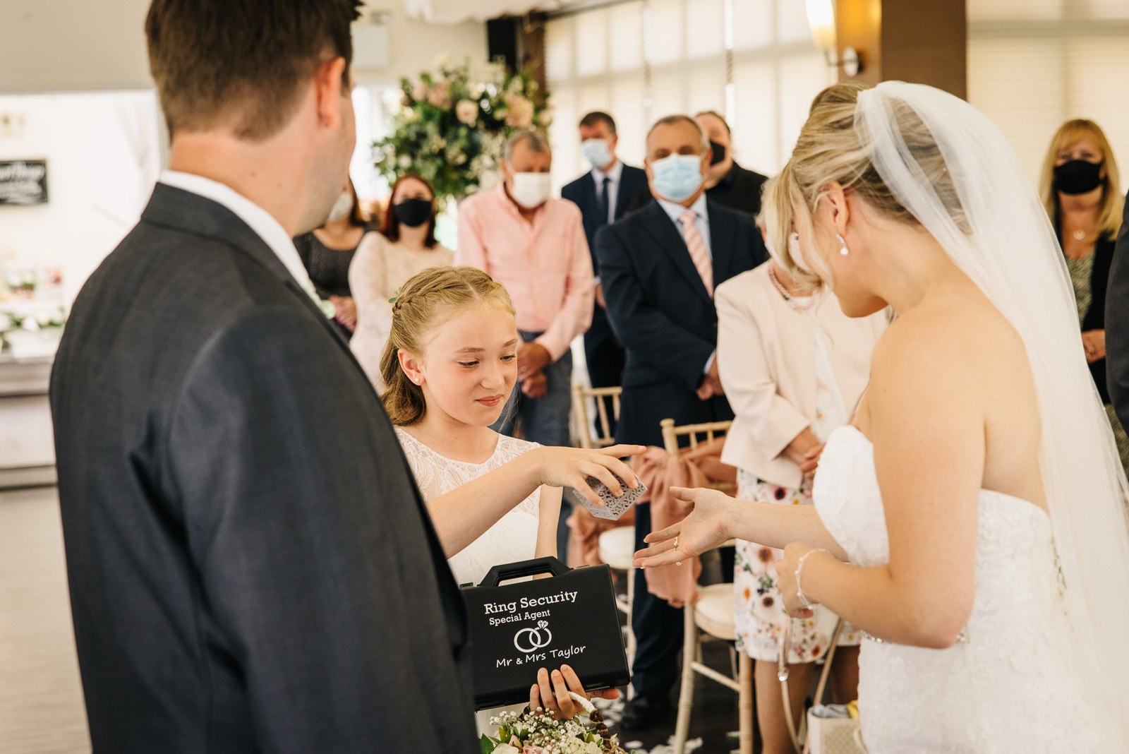 A young ring bearer bringing the rings as the couple prepare to exchange them
