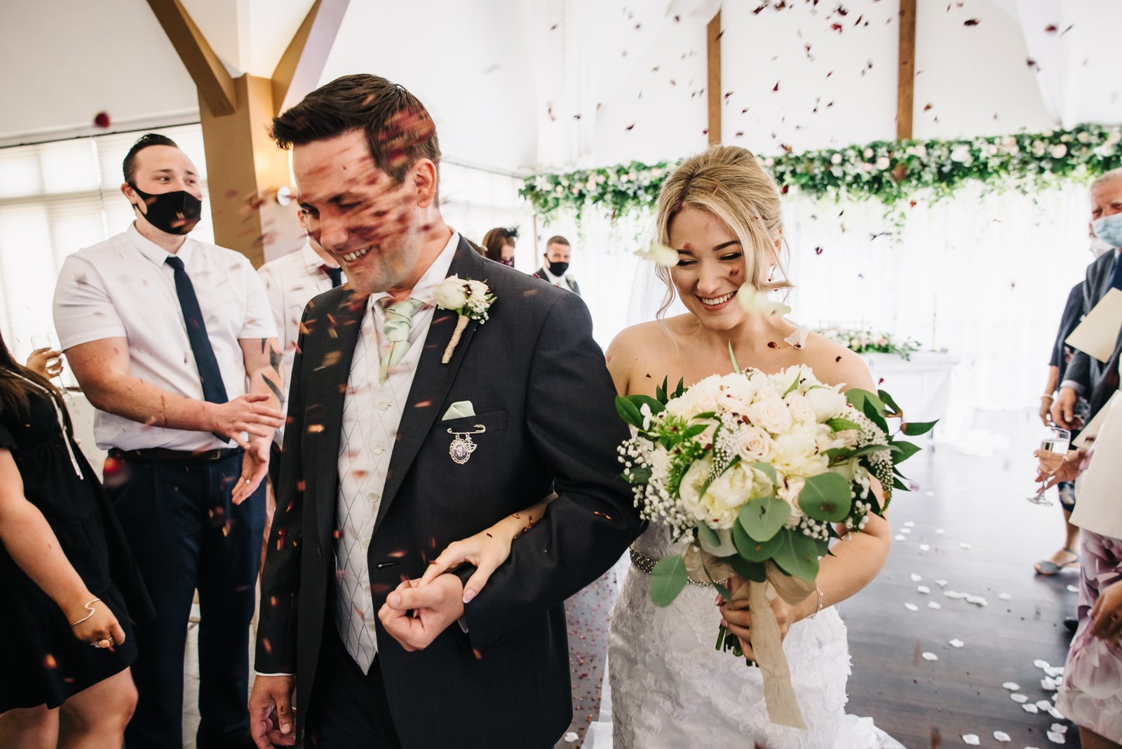 Confetti showering the bride and groom indoors after the ceremony