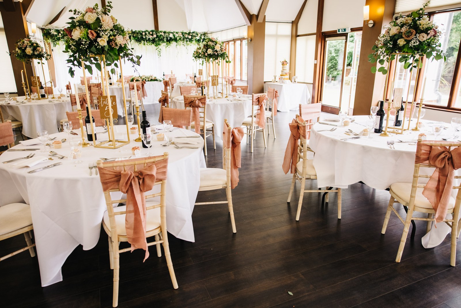 The Steventon House Hotel reception room set with round tables and peach chair sashes