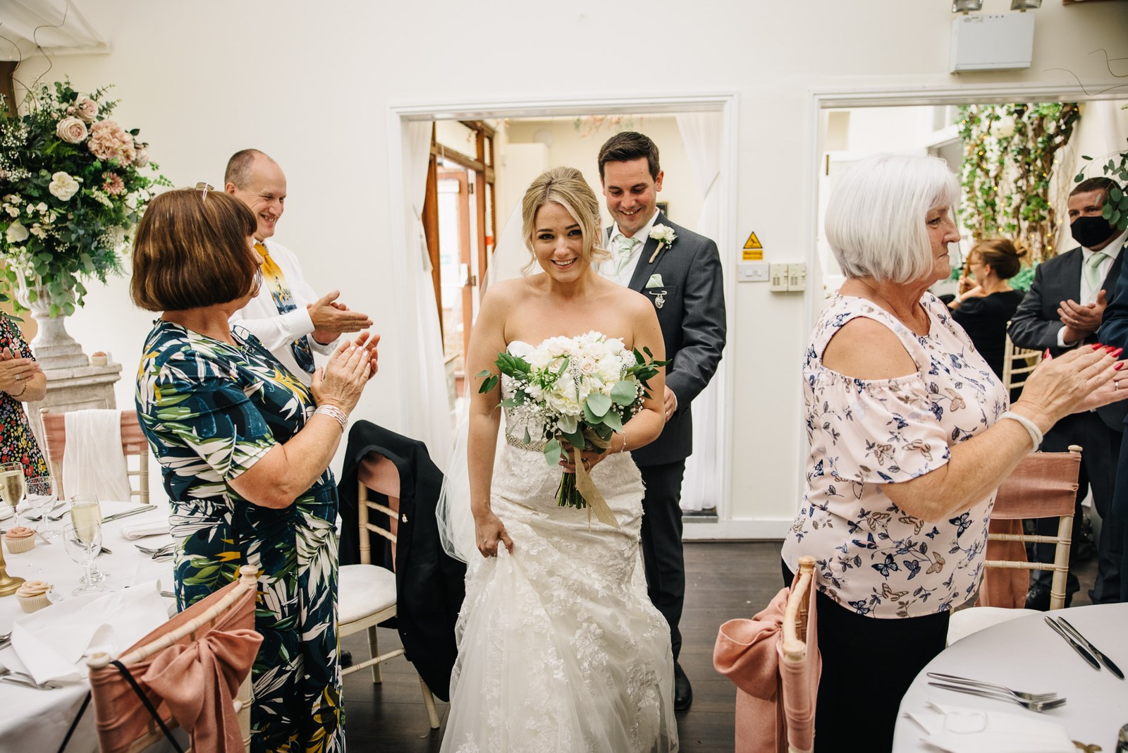 The newlyweds entering the reception to applause from their guests