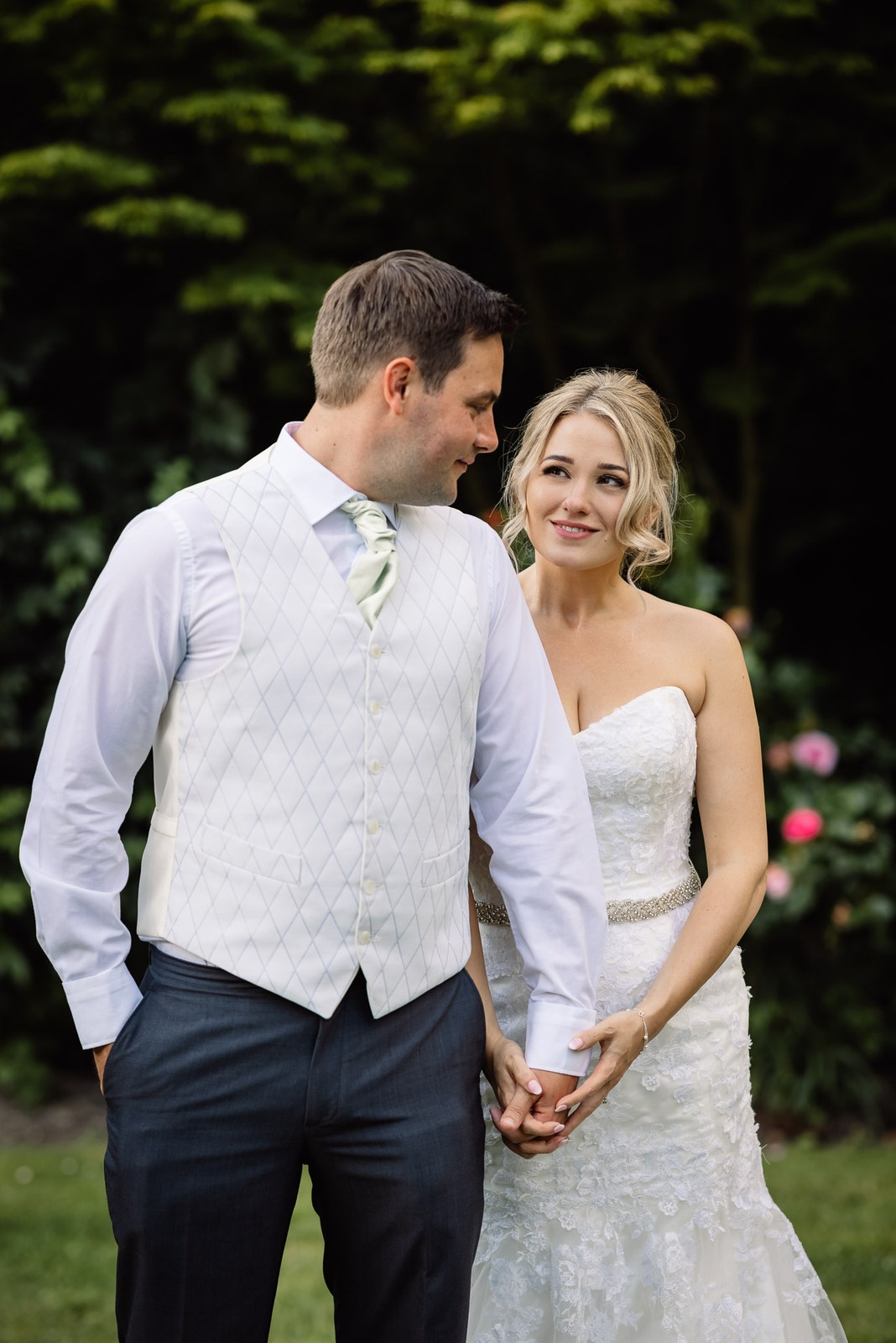 Bride and groom holding hands in the leafy Steventon House Hotel garden