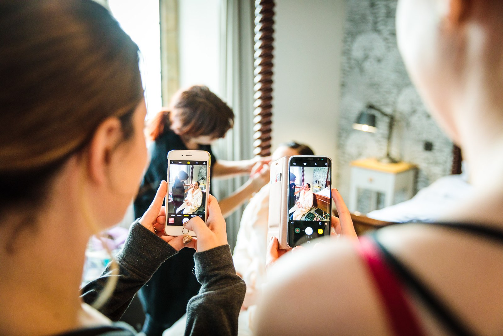 Guests capture the bride on their phones during the morning preparations