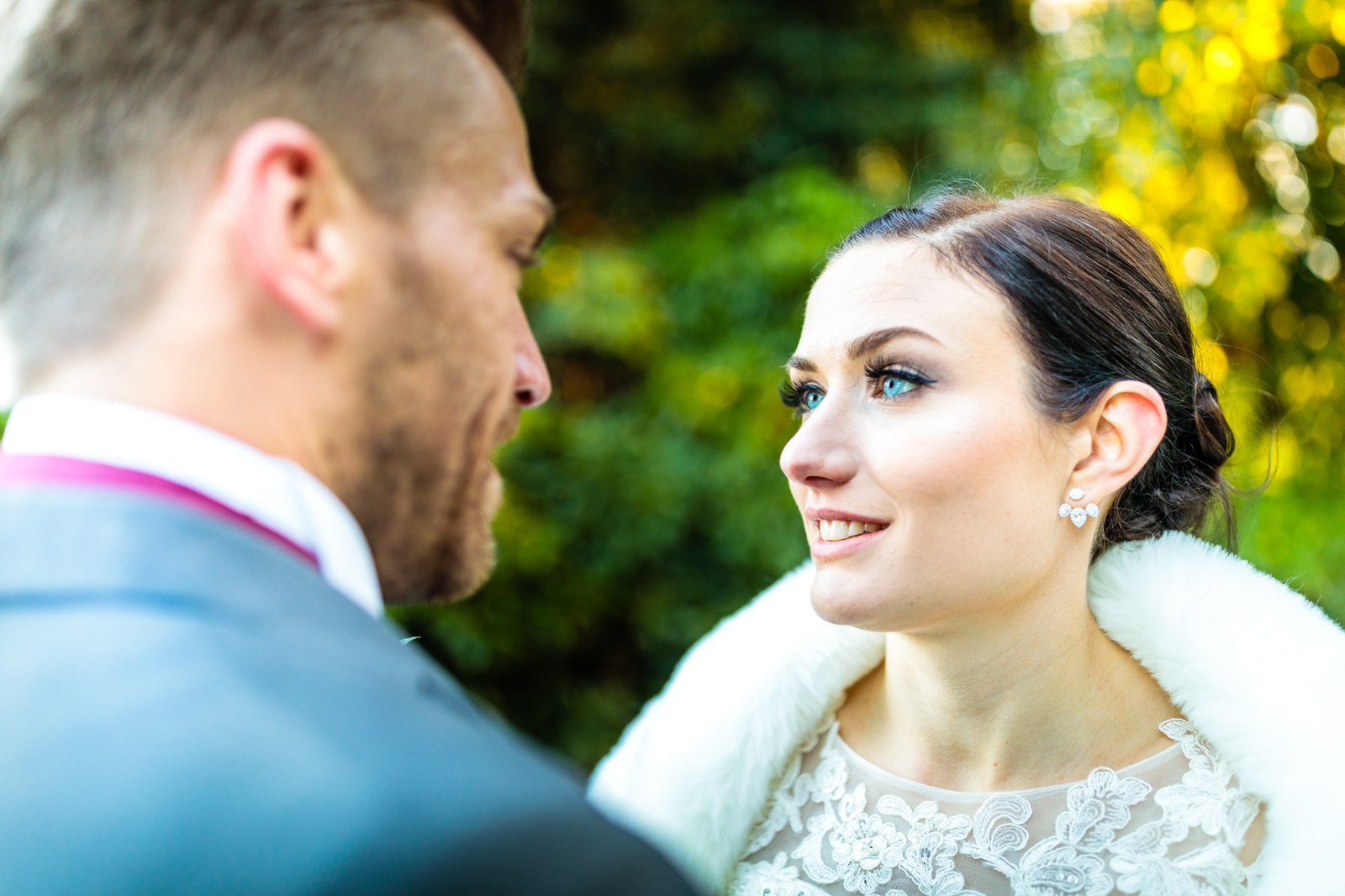 Close-up of the couple in profile, the bride in her fur stole